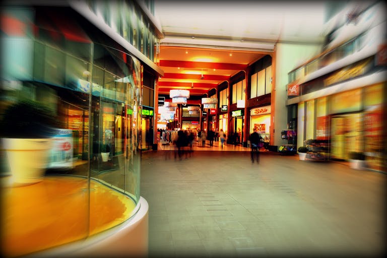 Explore the lively atmosphere of a modern shopping mall in Hoofddorp, Netherlands, captured with vibrant colors and motion blur.