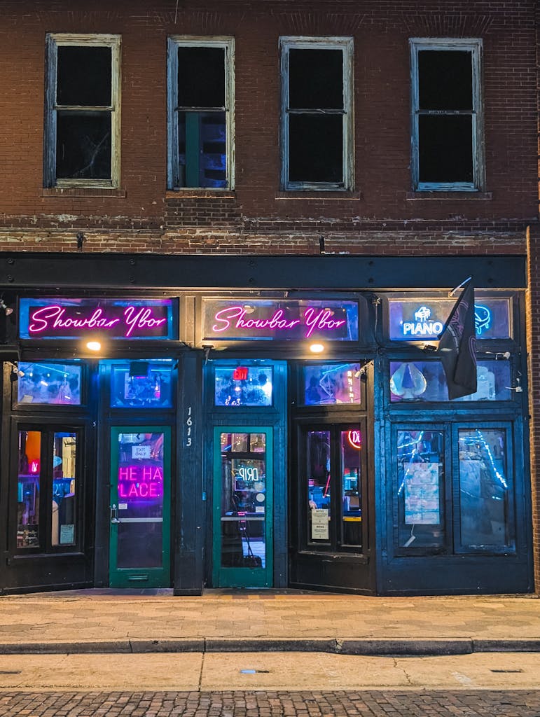 Lively exterior of Showbar Ybor captured at night in Tampa, Florida. Neon lights set the mood.