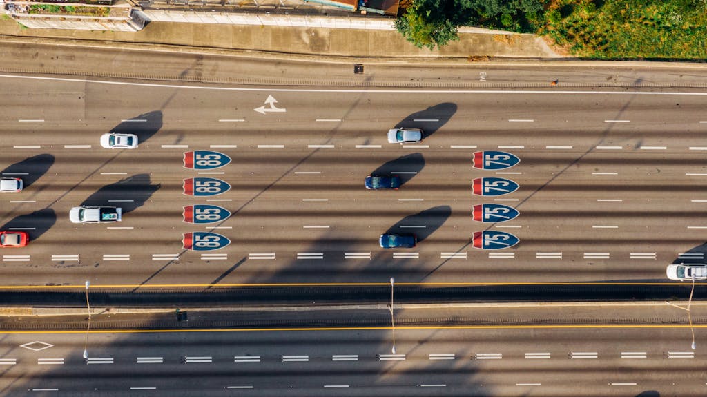 Overhead view of cars on Atlanta's I-85 and I-75 highways on a sunny day.